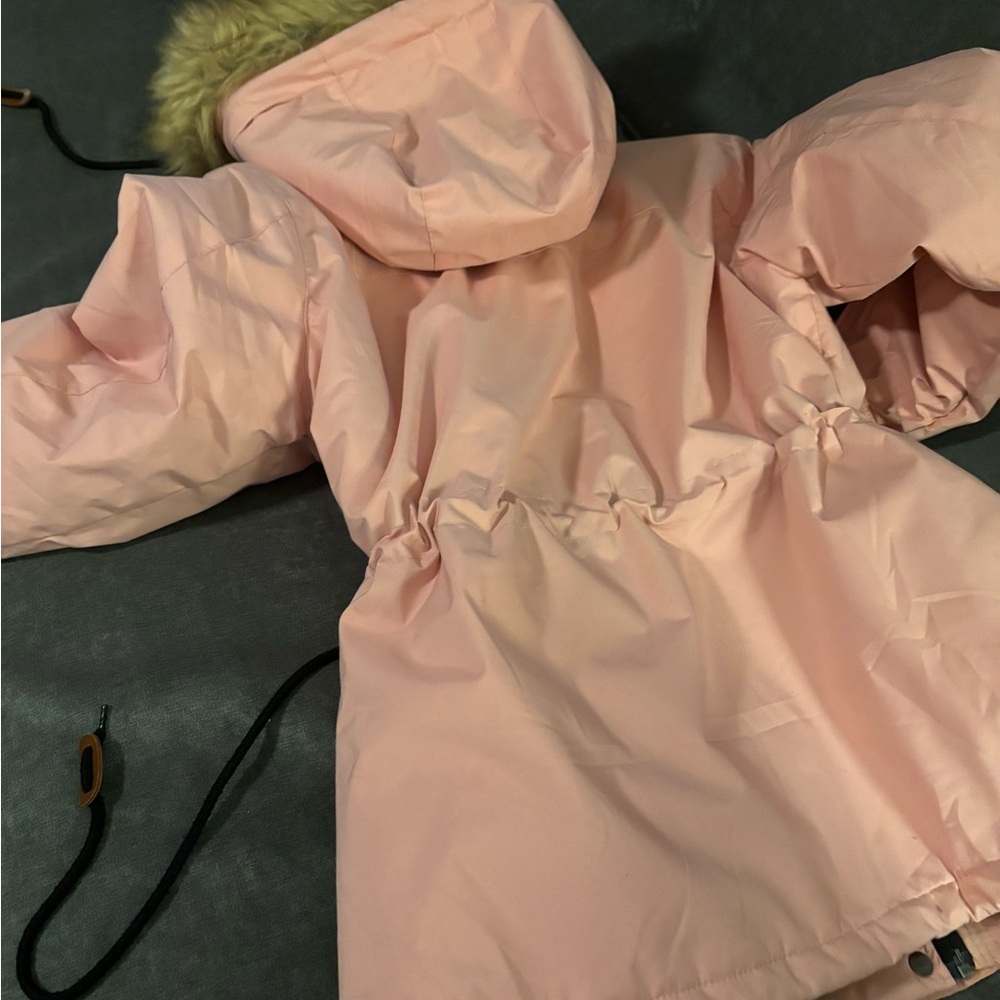 Pink waterproof wind proof warm small jacket with cinch waist and bottom.